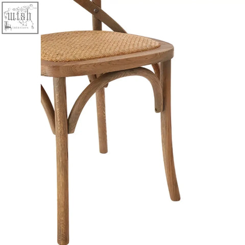 Light brown grey oak wood and cane chair with a curved leg design and classic cane chair weave seat