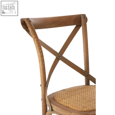 A rustic grey oak wood cane chair weave seat with crossed back slats and natural finish woven wicker seat