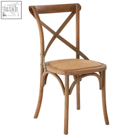 A rustic lyon grey oak wood cane chair with an x-shaped backrest and a woven cane chair weave seat