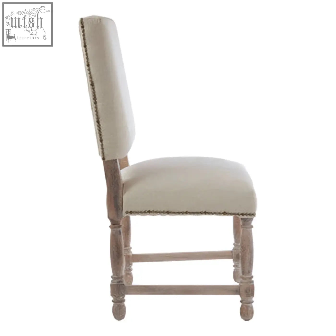 Beige linen dining chair with subtle nailhead trim and oak wood whitewash finish on wooden legs
