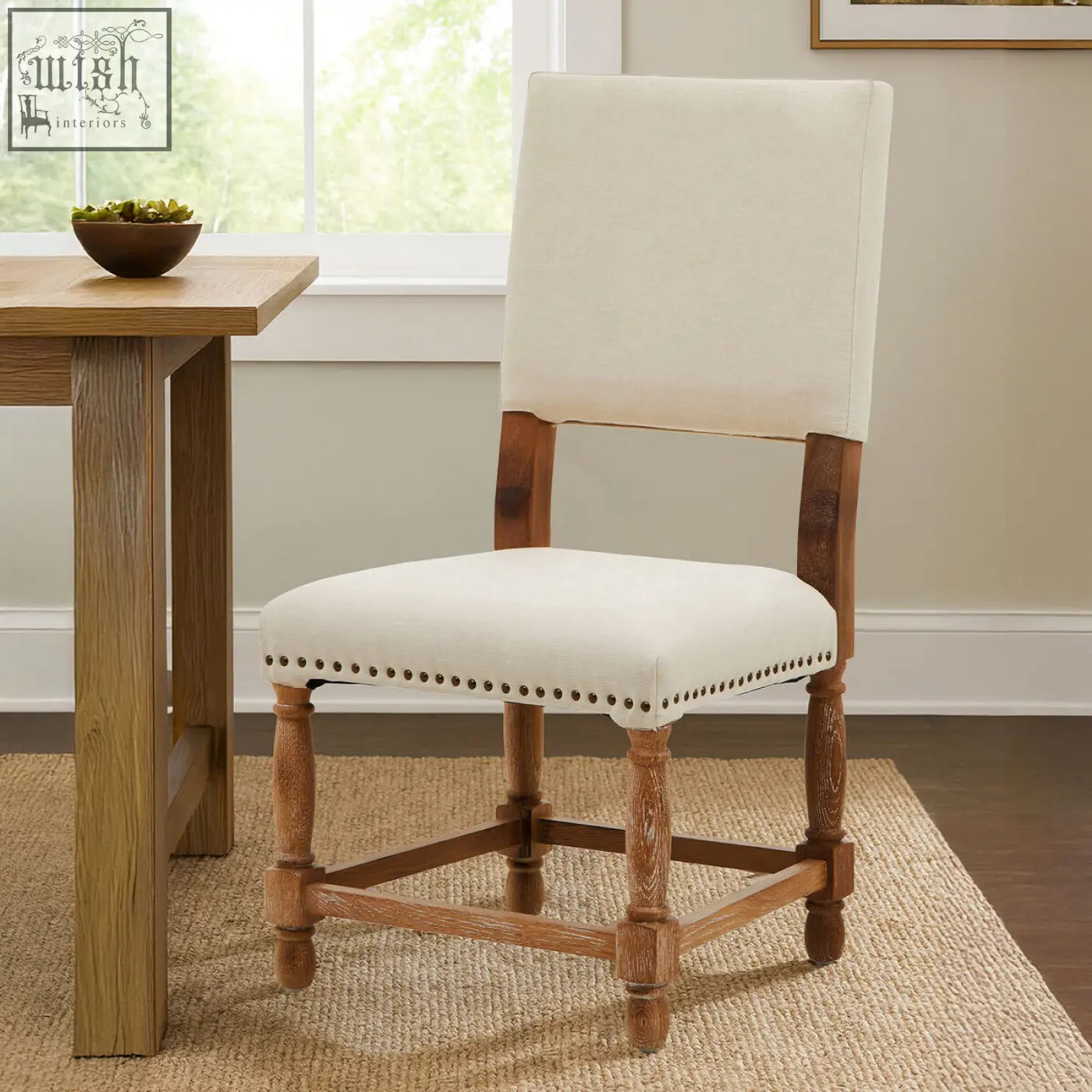 Cream-colored linen dining chair with classic design and oak wood whitewash finish wooden legs