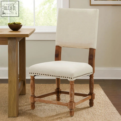 Cream-colored linen dining chair with classic design and oak wood whitewash finish wooden legs