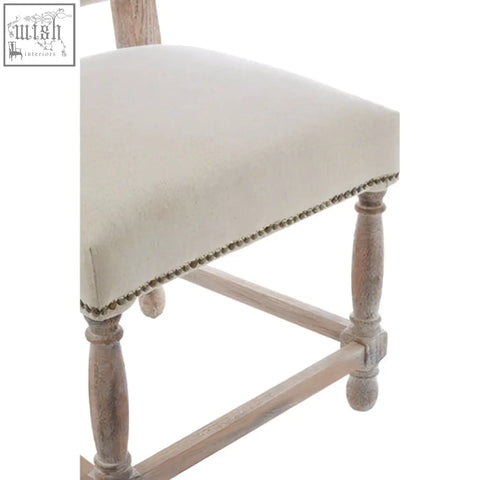 Rustic lyon linen dining chair with light beige seat and oak wood whitewash finish on distressed legs