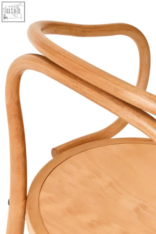 Light-colored lyon natural beech wood dining chair with curved interwoven frame and circular seat