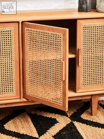 A light oak wood door sideboard with lyon rattan woven cane panels and one open door showing an empty shelf