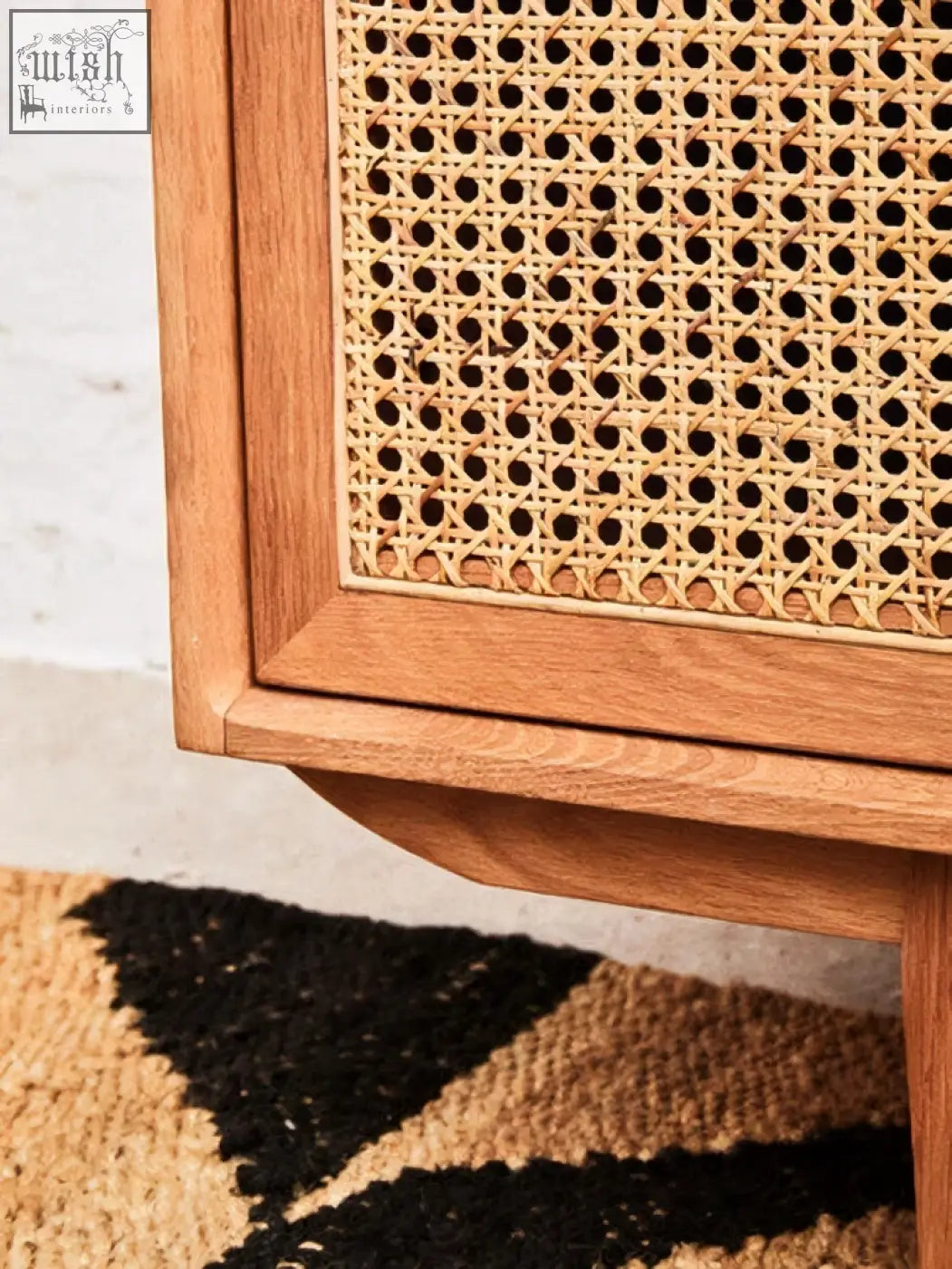 A natural oak wood door sideboard with lyon rattan woven cane panel and evenly spaced circular holes