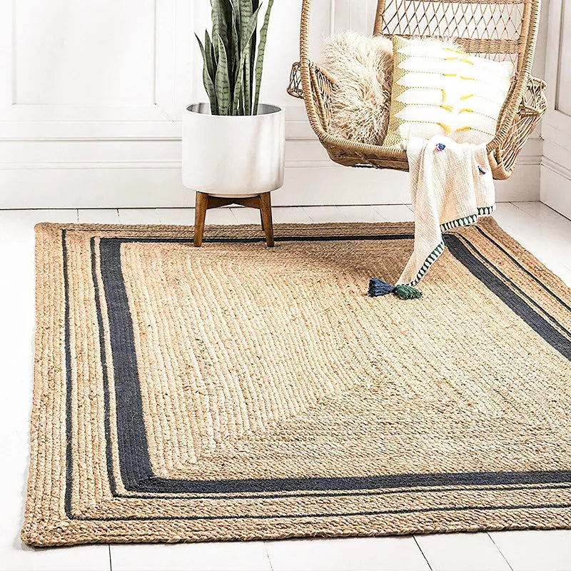 Natural fiber machine rug with textured beige center and dark navy border stripes in rectangular shape