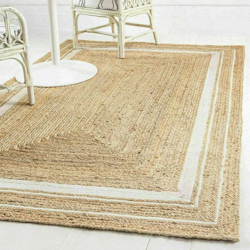 Natural fiber machine rug with textured woven design and contrasting light beige border for stylish floors