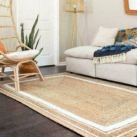 Natural fiber machine rug with a beige woven body and white striped border for stylish home decor