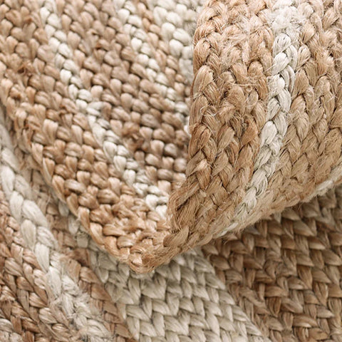 Machine rug made of woven jute and off-white material with a textured braided pattern for stylish floors