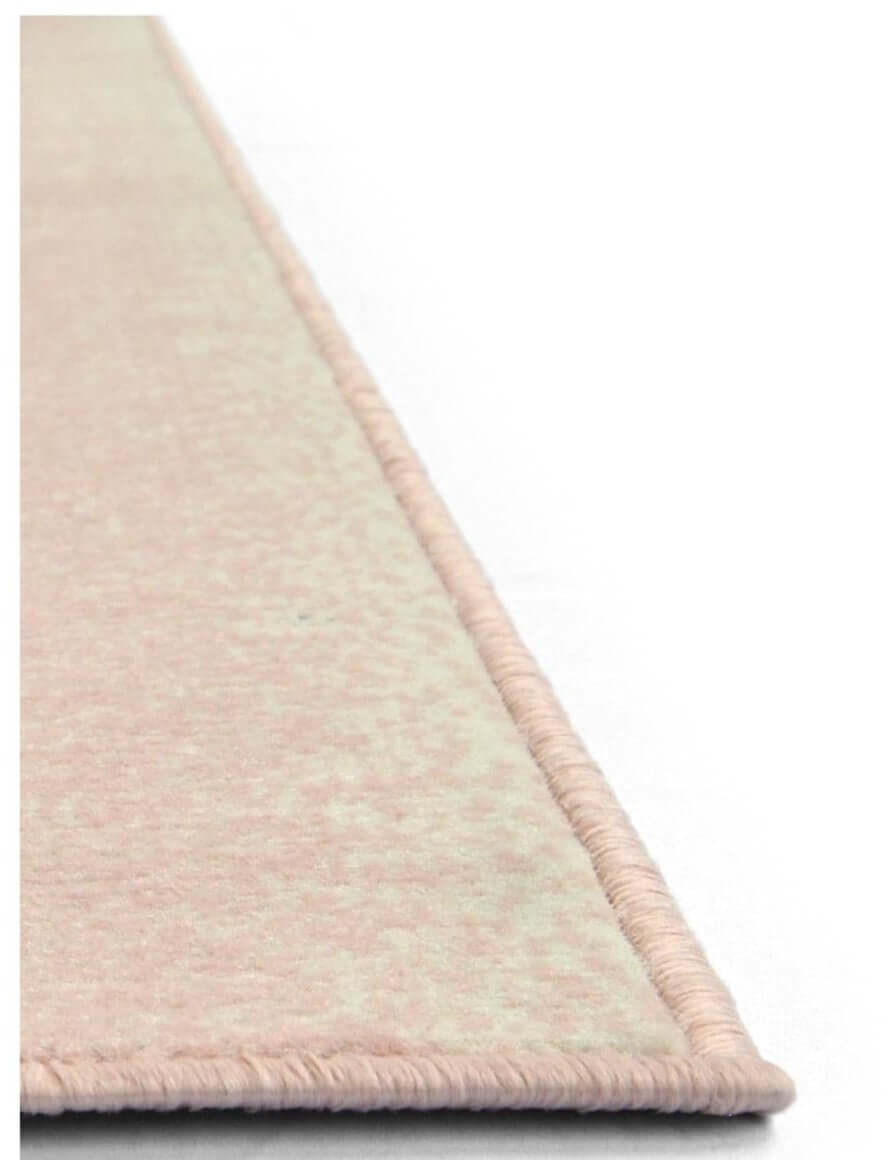 A soft blush pink maestro ombre pink rug with a textured woven surface and neatly finished edges