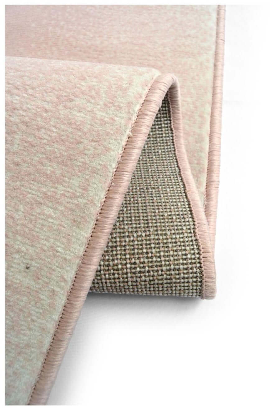 A soft blush pink maestro ombre pink rug with a plush textured surface and neatly stitched edges perfect for cozy spaces