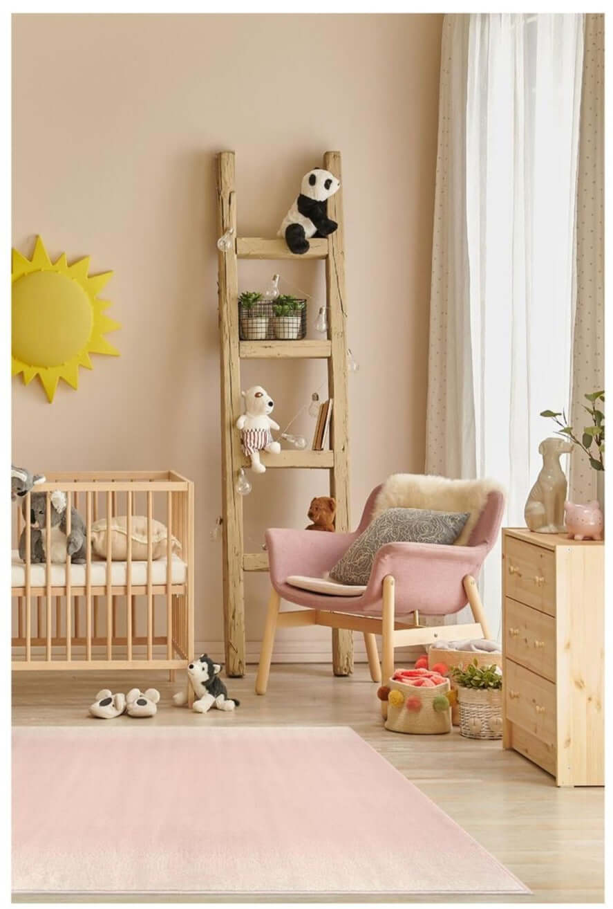 Pink upholstered armchair with wooden legs and fluffy white cushion on a maestro ombre pink rug 3797 gb33