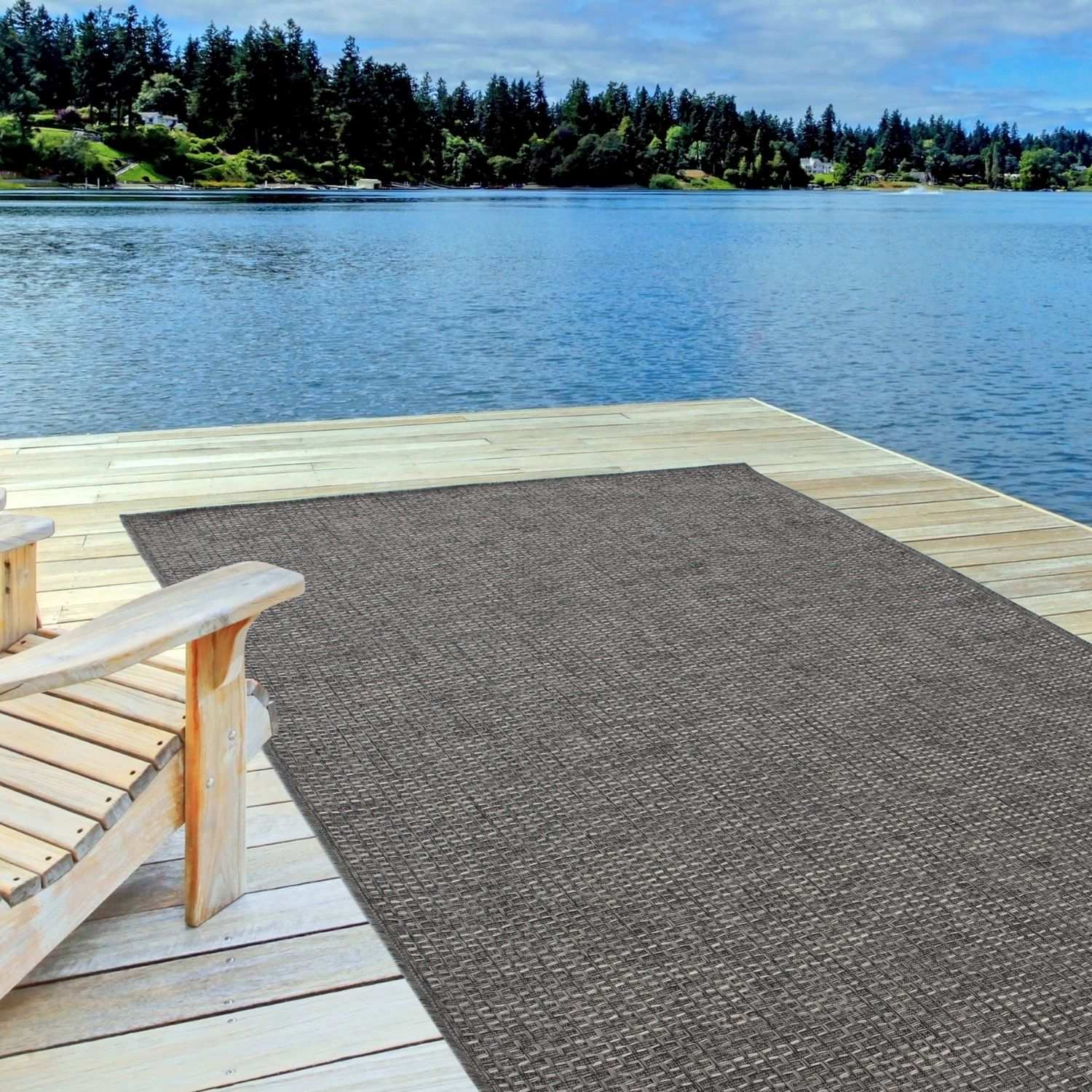 Brown woven outdoor rug on wooden dock showcasing magic outdoor rug dark grey for stylish outdoor use