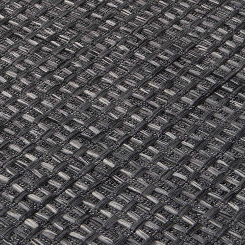Dark grey magic outdoor rug featuring a textured woven textile with light and dark grey interlaced pattern