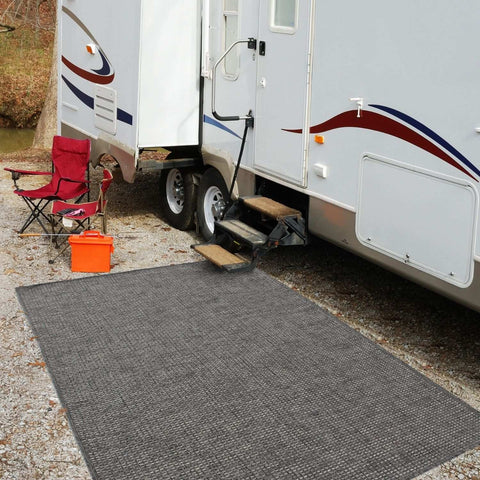 Gray textured magic outdoor rug dark grey placed in front of an rv as an outdoor rug mat