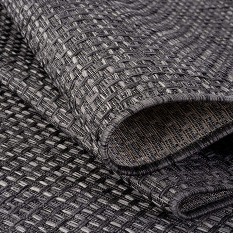 Dark grey woven outdoor rug with textured interlaced pattern and frayed edges magic outdoor rug 3610dg