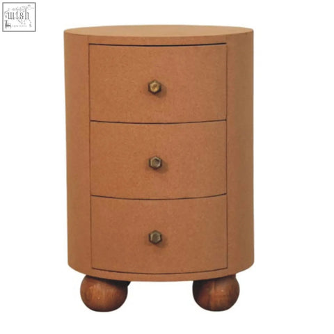 Tan cylindrical nightstand storage unit with three drawers, hexagonal brass knobs, and rounded wooden ball feet by maison liège