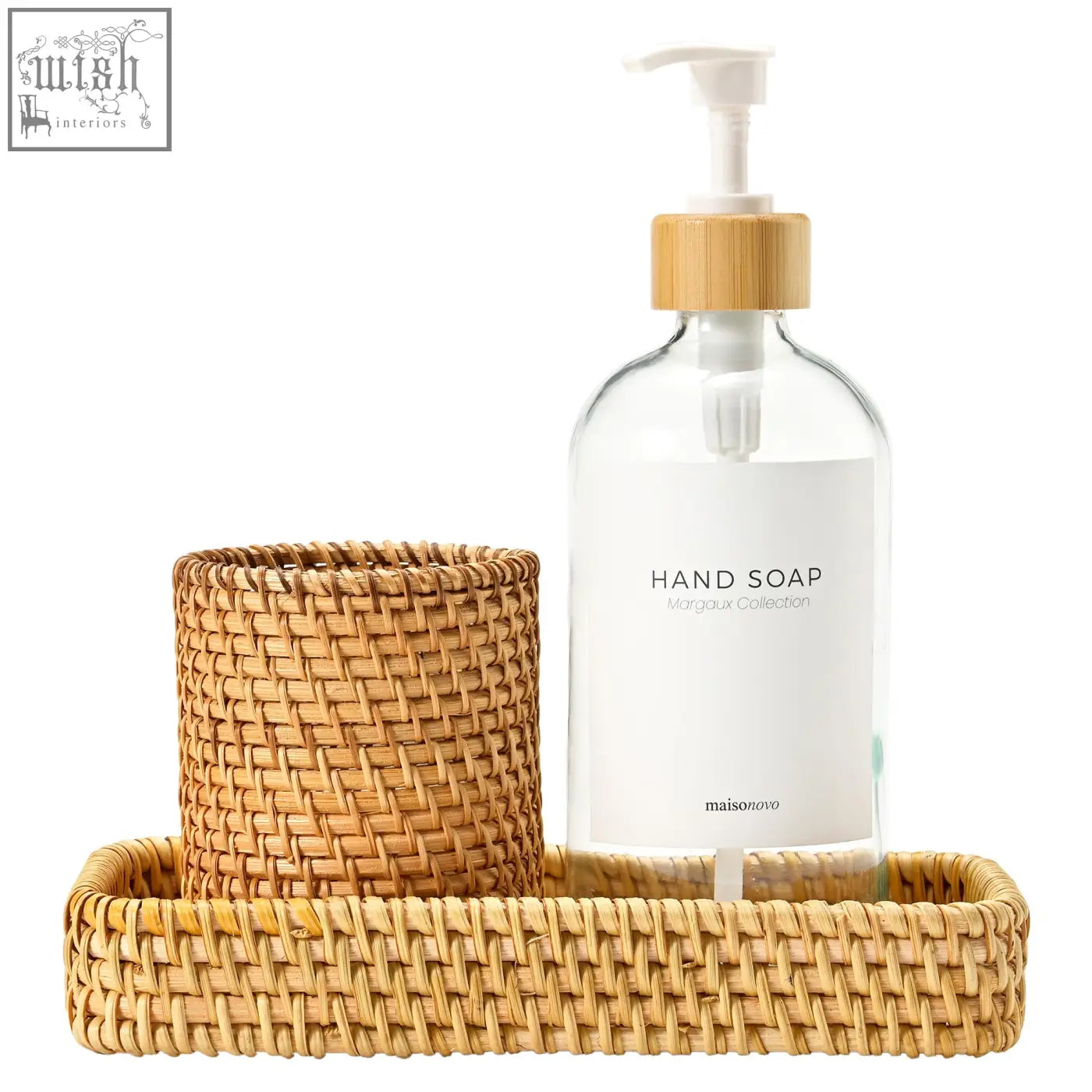 Clear glass countertop dispenser with bamboo pump and white label in a rattan bathroom tray from maisonovo set