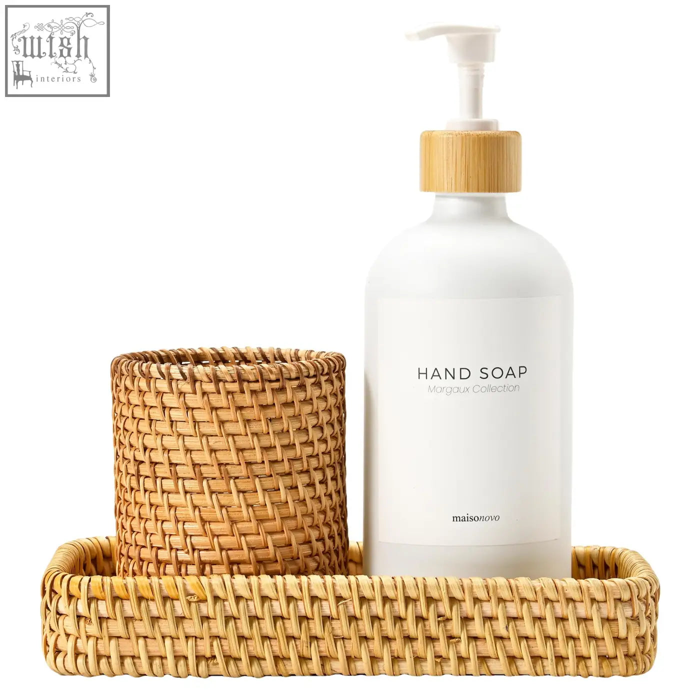 White glass hand soap bottle with bamboo pump and minimalist label in rattan bathroom countertop dispenser tray set