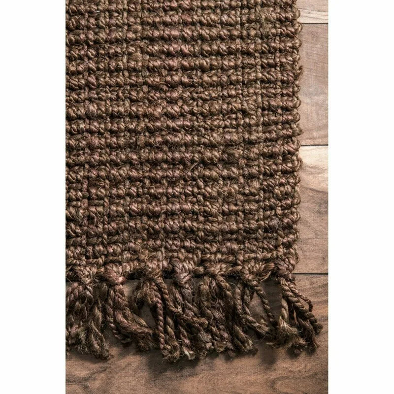 Brown woven makasi rug with textured braided pattern and fringed edges perfect for cozy spaces