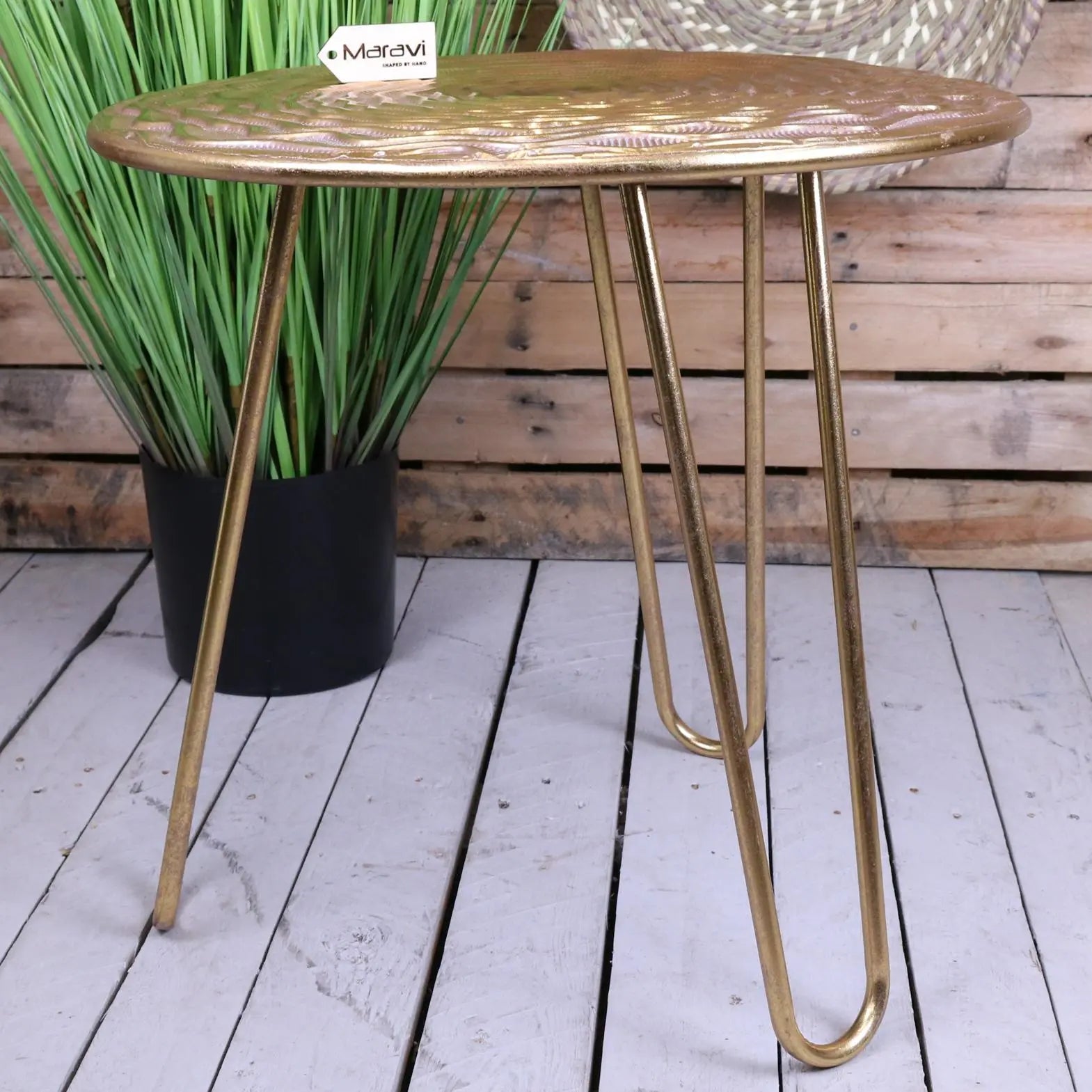 Gold-finished malan gold tripod side table with embossed floral top and sleek metal hairpin legs