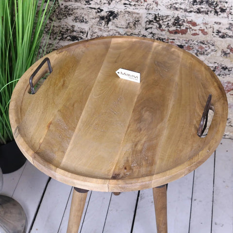 Round wooden malipara basket side table with metal basket handles and three wooden legs in natural finish