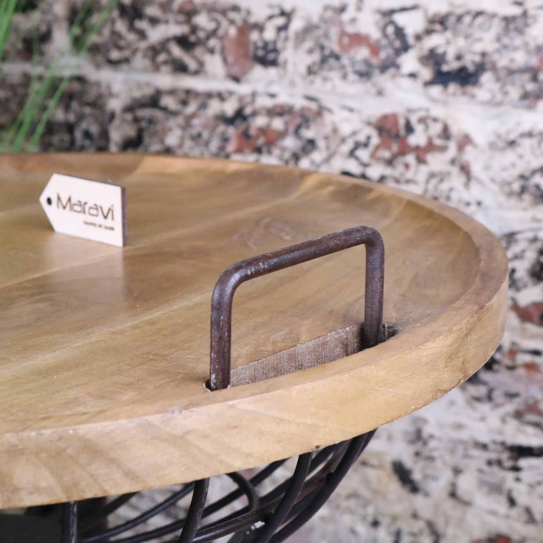 Malipara basket side table with a rustic round wooden tray, dark metal handle, black wire base, and wooden legs removable table