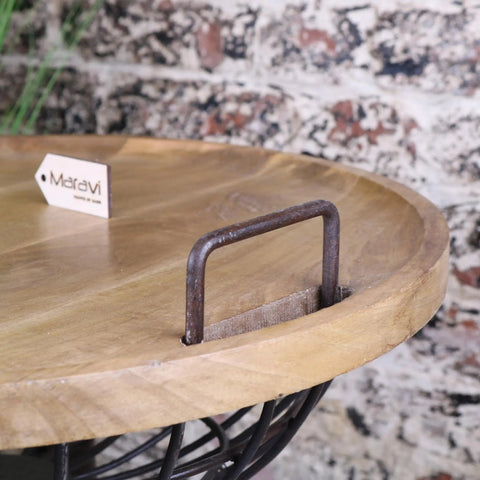 Malipara basket side table with a rustic round wooden tray, dark metal handle, black wire base, and wooden legs removable table