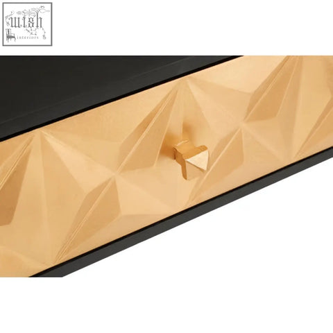 Gold-colored geometric patterned drawer front with matching triangular pull handle on malta console table