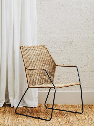 Manado angled design natural rattan chair with woven natural fiber and sleek black metal frame for stylish seating
