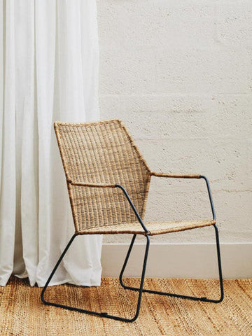 Manado angled design natural rattan chair with woven natural fiber and sleek black metal frame for stylish seating