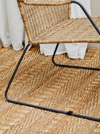 Manado angled design natural rattan chair with woven rattan seat and black metal frame for stylish seating