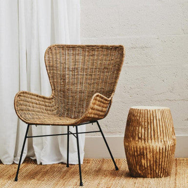 Manado curved design natural rattan chair with woven rattan seat and black metal legs for stylish seating