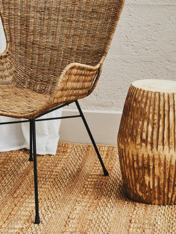Manado curved design natural rattan chair with woven rattan seat and black metal legs for stylish seating