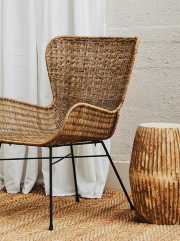 Manado curved design natural rattan chair with woven rattan seat and black metal legs for stylish seating