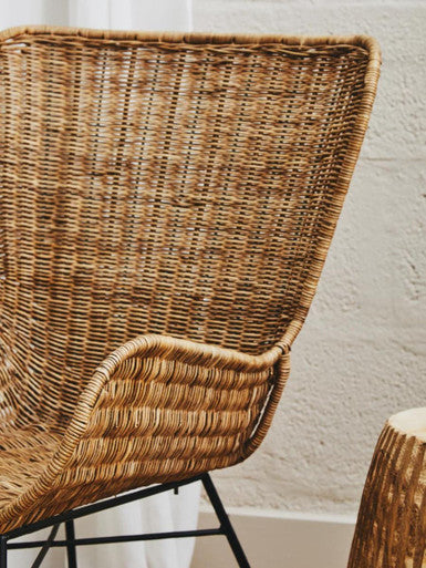 Manado curved design natural rattan chair with tan woven rattan seat and black metal frame for stylish seating