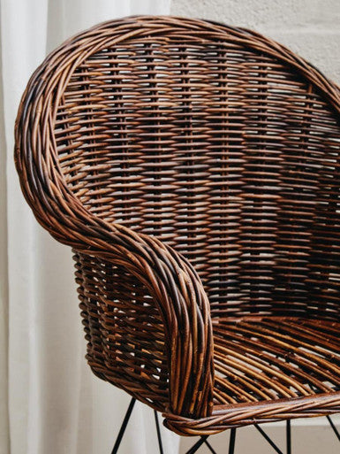 Brown woven manado natural croco rattan chair with curved back and armrests perfect for cozy seating