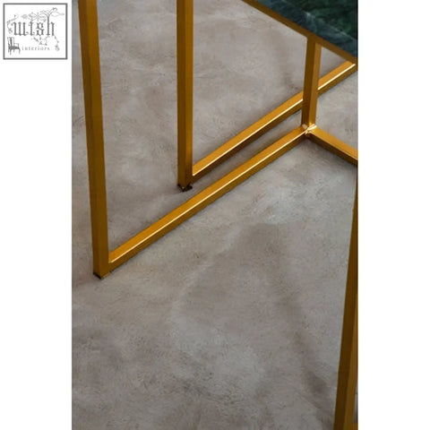 Gold-toned metal legs of mandoli nest of 2 green marble side tables with interconnected gold modern design