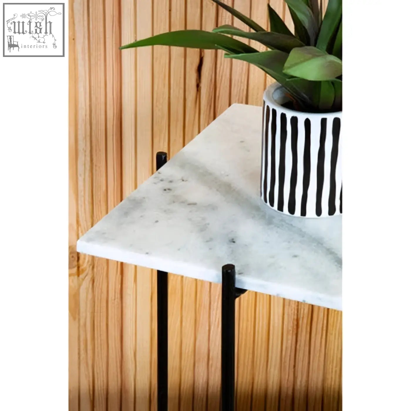 Mandoli white marble side table with white marble top and black iron frame holding a striped ceramic pot with greenery