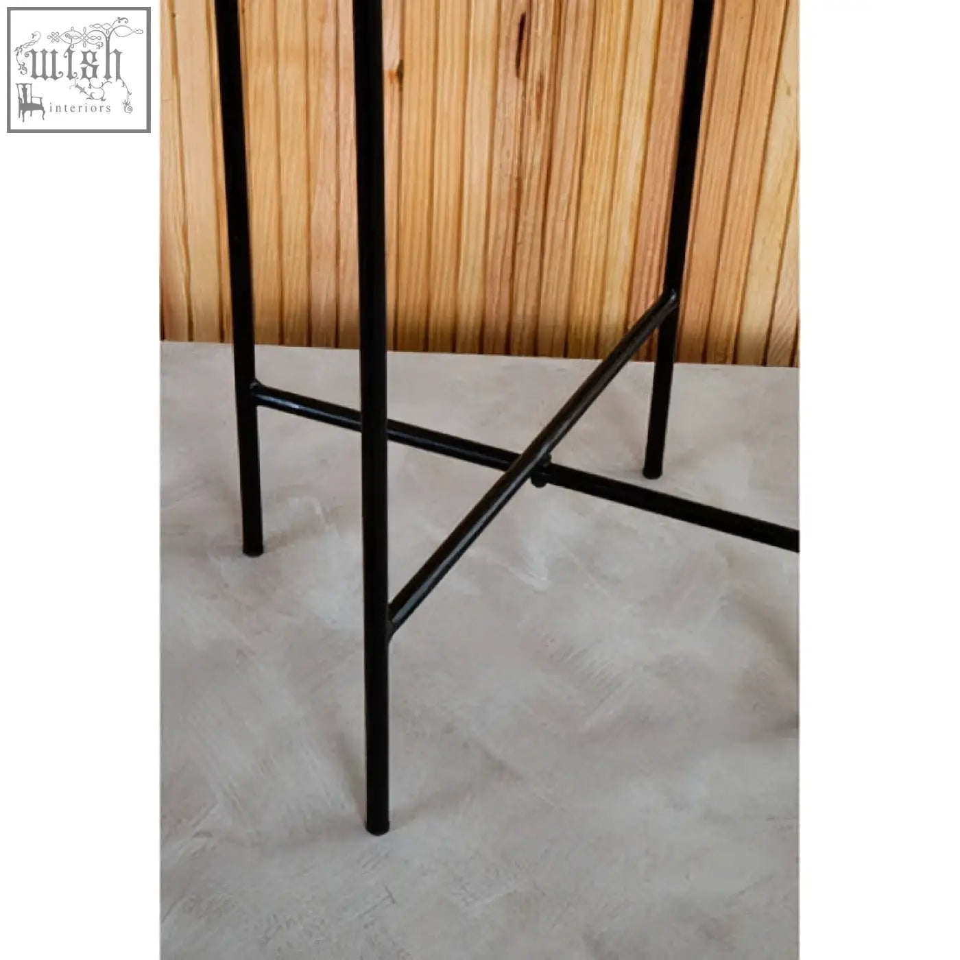 Black metal legs of mandoli white marble side table with iron frame and minimalist industrial design