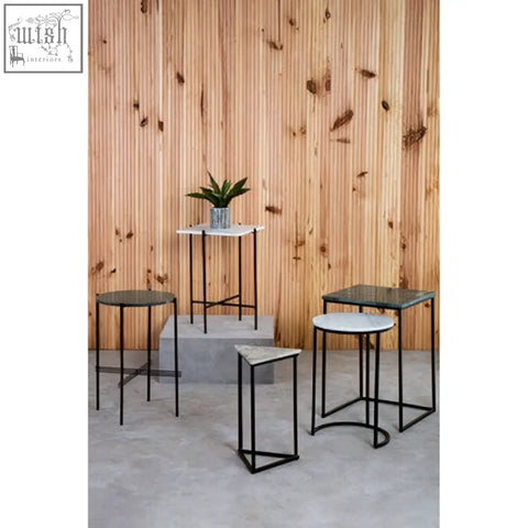 Set of modern minimalist bar stools with black iron frame and white marble tops next to mandoli white marble side table