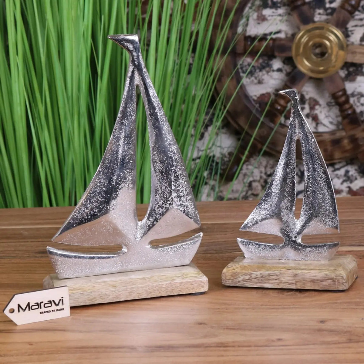 Silver metallic mandvi sailing boat ornament with textured glittery surfaces on wooden bases for decor