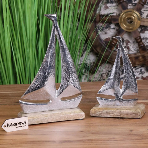 Silver metallic mandvi sailing boat ornament with textured glittery surfaces on wooden bases for decor