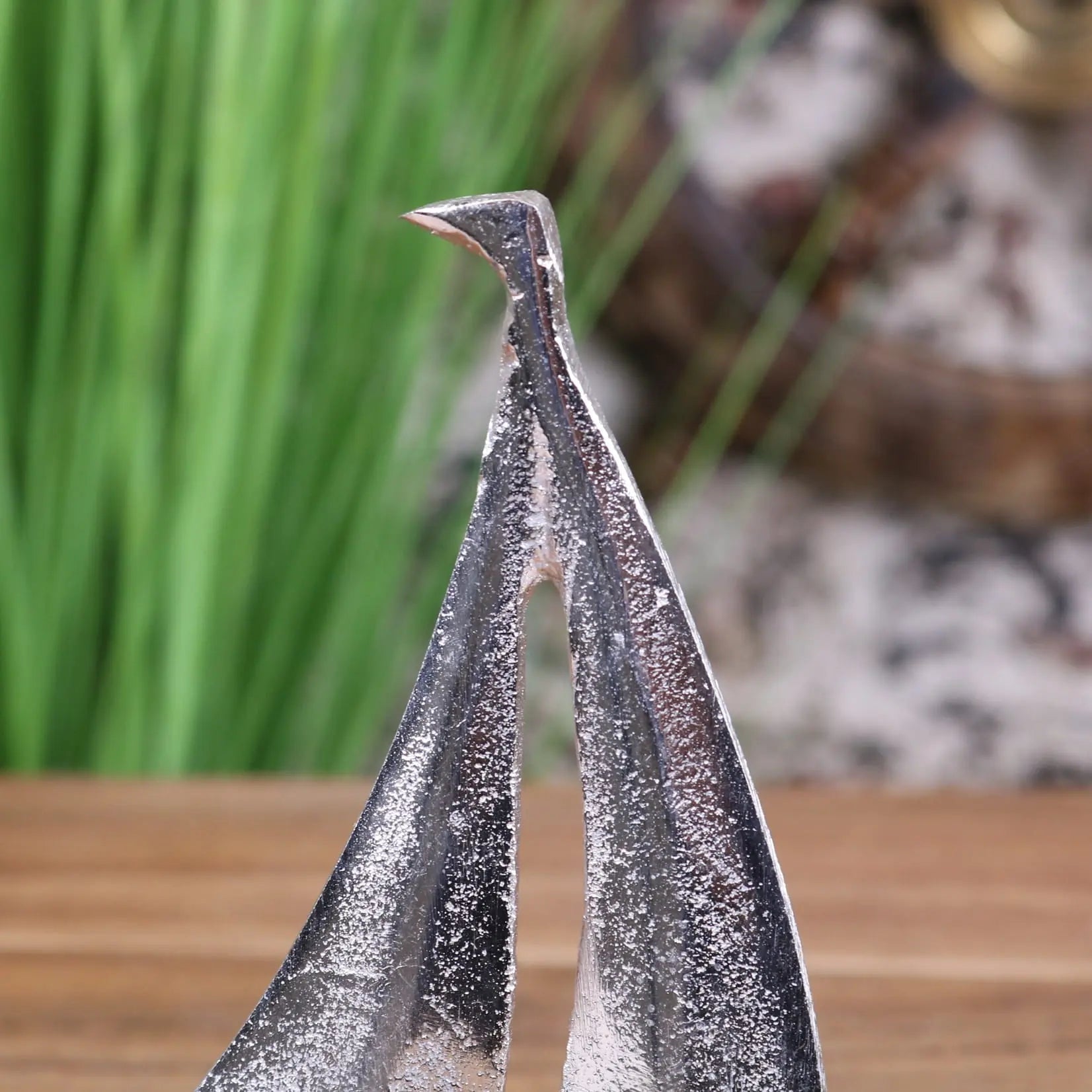 Silver-toned metal bird sculpture with textured finish and pointed beak for mandvi sailing boat ornament model