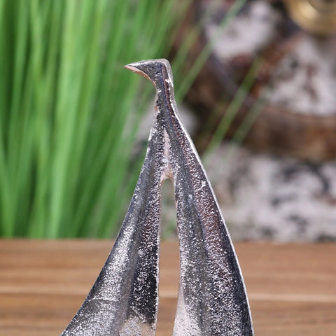 Silver-toned metal bird sculpture with textured finish and pointed beak for mandvi sailing boat ornament model