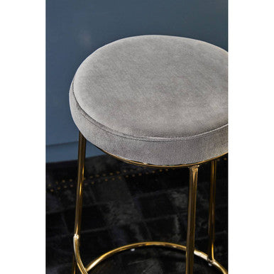 Manhattan grey velvet tall bar stool with round grey velvet seat and slender gold metal legs for stylish seating