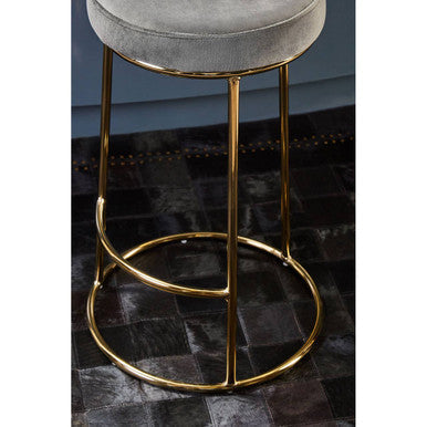 A sleek manhattan grey velvet tall bar stool with a plush grey velvet seat and gold-toned slender legs