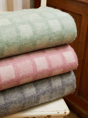 Stacked manhattan pure new wool throws in soft pastel plaid with intricate square patterns and manhattan skyline colors