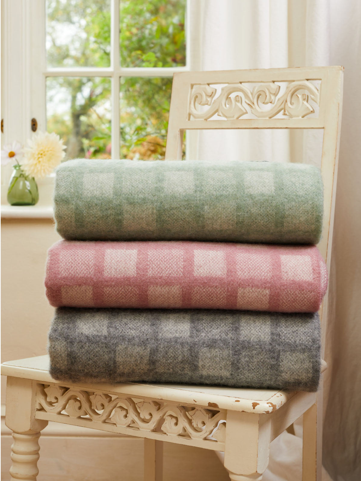 Stacked manhattan pure new wool throws with soft pastel plaid patterns in green pink and gray featuring intricate square design